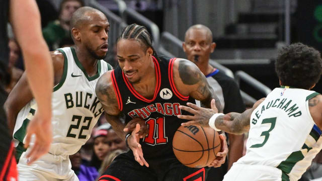 Chicago Bulls guard DeMar DeRozan (11) gets pressure from Milwaukee Bucks center Khris Middleton (22) and guard MarJon Beauchamp (3) in the fourth quarter at Fiserv Forum.